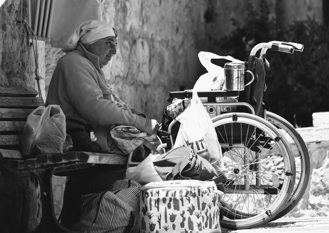 a man sitting on a bench next to a bike